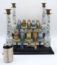 A large pair of porcelain double candlestick holders decorated with budgerigars sitting on a perch 3