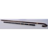 A wooden walking cane with a 9 Ct gold collar stamed 1928 together with another leather encased