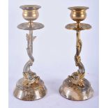 A PAIR OF REGENCY COUNTRY HOUSE SILVERED BRONZE CANDLESTICKS formed as fish. 18cm high.