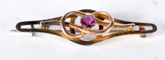 A 9 Carat Gold Bar Brooch set with an Amethyst. Stamped 9CT. 4.4cm x 1.2 cm, weight 2.3g