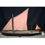 A large wooden model of a Thames sailing barge 130 x 29 cm.