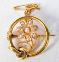 A 15 Carat Gold Flower Brooch set with Pearls with Safety Chain. Stamped 15 CT. 2.1cm diameter,