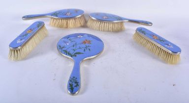 AN ART DECO ENAMELLED DRESSING TABLE SET decorated with flowers. Largest 27cm x 12cm. (4)