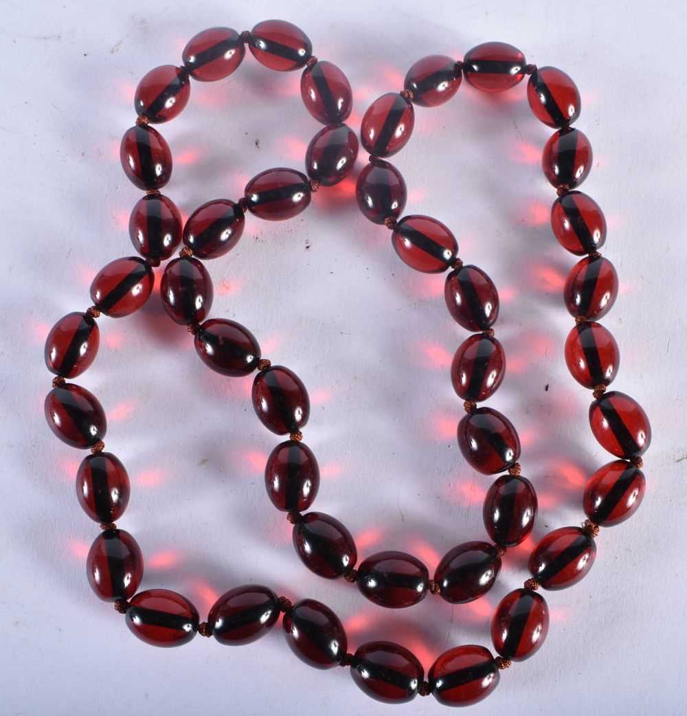 A CHERRY AMBER TYPE RED BEAD NECKLACE. 85 grams. 82 cm long. - Image 3 of 3