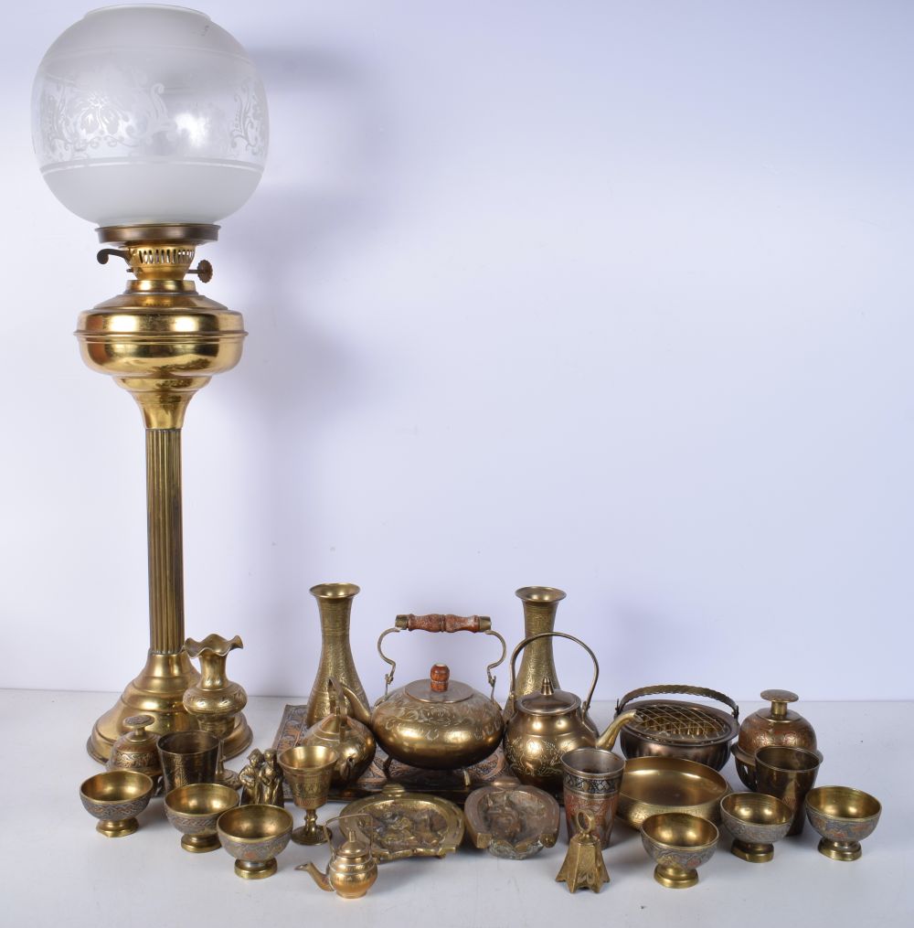 A collection of Central Asian brass items , together with a brass oil lamp with an etched glass