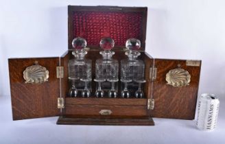 A LARGE LATE VICTORIAN OAK CASED TANTALUS the top and front opening to reveal a fully fitted
