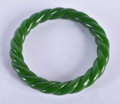A CHINESE CARVED SPIRAL JADE BANGLE 20th Century. 38.4 grams. 6 cm diameter.