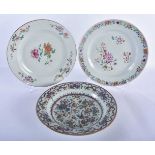 THREE 18TH CENTURY CHINESE FAMILLE ROSE PLATES Qianlong, painted with flowers. 23.5 cm diameter. (