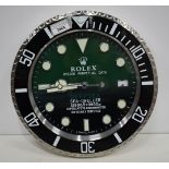 A Contemporary Rolex style dealership clock 33 cm.