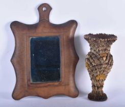 AN UNUSUAL ANTIQUE COUNTRY HOUSE SHELL OVERLAID POTTERY VASE together with a leather mirror. Largest