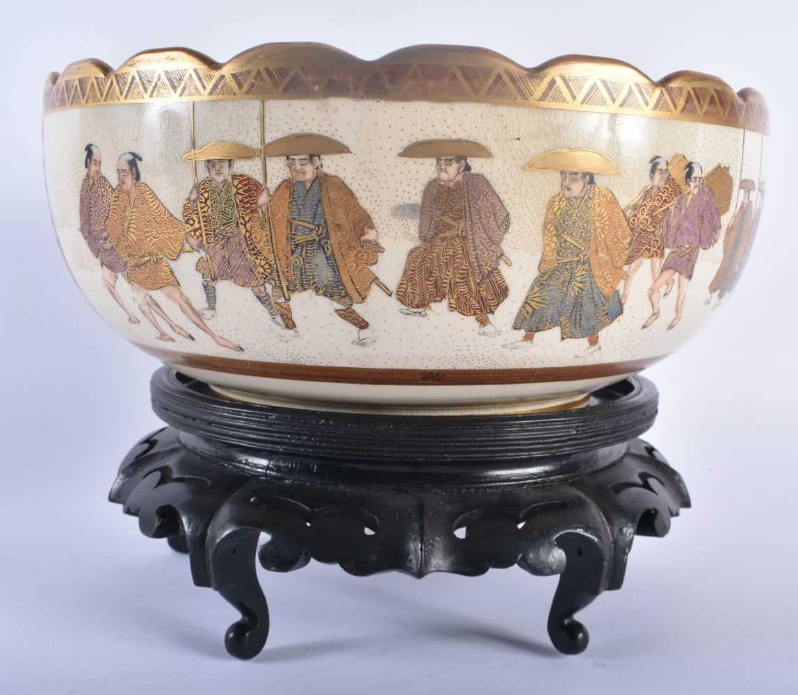 A LARGE LATE 19TH CENTURY JAPANESE MEIJI PERIOD SATSUMA BOWL painted with figures within landscapes.
