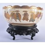 A LARGE LATE 19TH CENTURY JAPANESE MEIJI PERIOD SATSUMA BOWL painted with figures within landscapes.