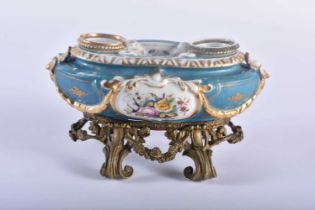 A 19TH CENTURY FRENCH PARIS SEVRES TYPE PORCELAIN INKWELL upon a gilt bronze scrolling base. 23 cm x
