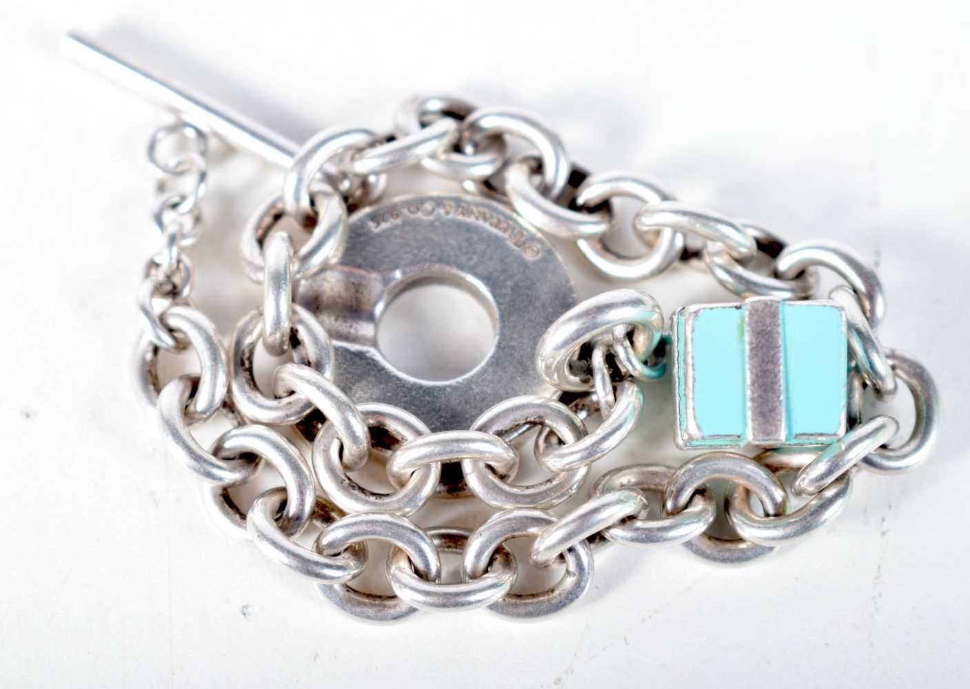 A Tiffany Silver Charm Bracelet with a Gift Box Charm. Stamped Tiffany 925, 21cm long, weight 38.7g - Image 2 of 2