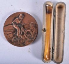 AN AMBER CHEROOT HOLDER and a vintage medallion. Largest 6 cm x 0.5 cm. (2)