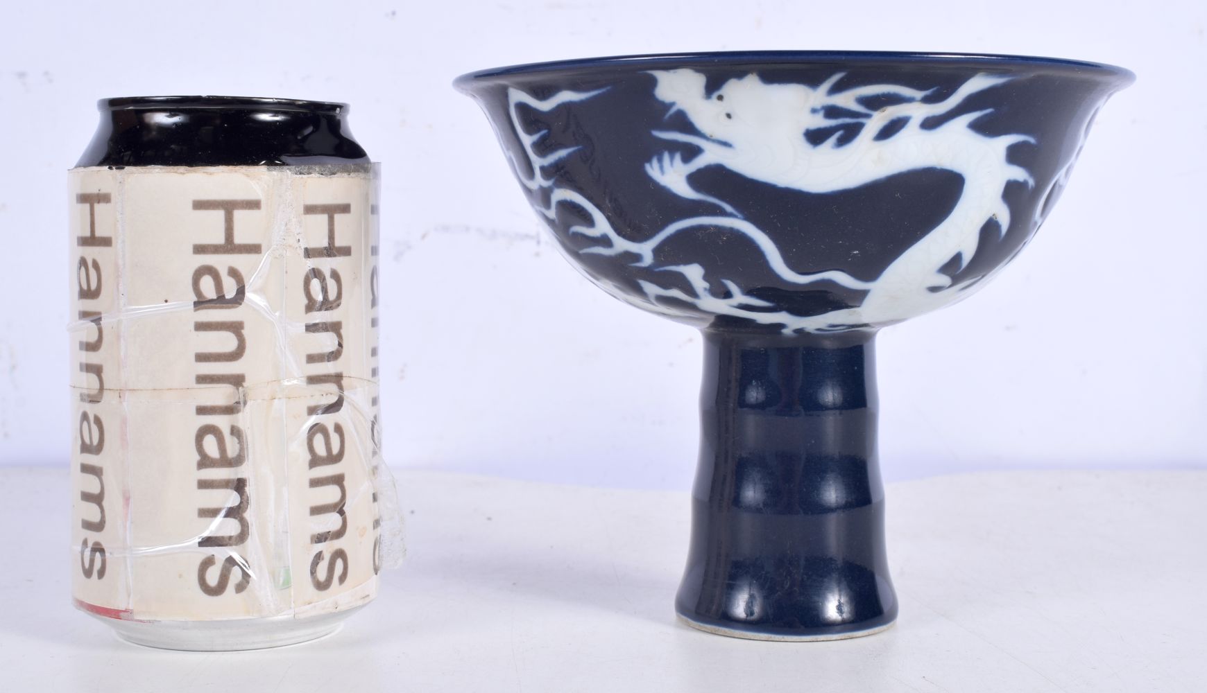 A Chinese Porcelain Sacrificial blueStem cup decorative in relief with a dragon 12.5 cm