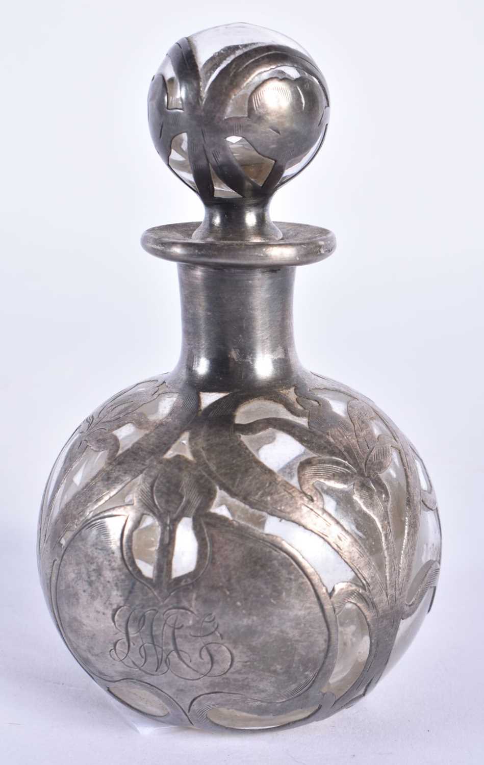 AN ART NOUVEAU SILVER OVERLAID GLASS SCENT BOTTLE AND STOPPER. 143 grams overall. 10.5 cm x 6.5 cm.