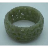 A CHINESE CARVED JADE RETICULATED BANGLE. 95 grams. 5.75 cm wide internally.