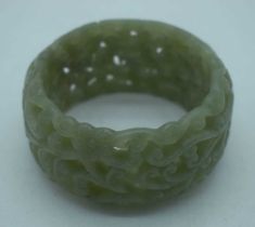 A CHINESE CARVED JADE RETICULATED BANGLE. 95 grams. 5.75 cm wide internally.