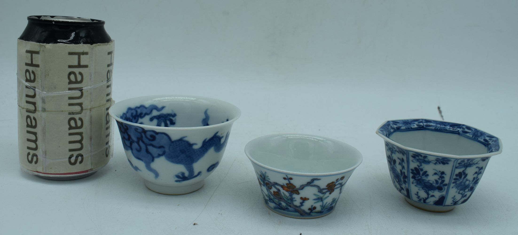 A small Chinese porcelain blue and white dragon bowl with two small bowls 6 x 9 cm. (3)