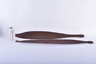 TWO ABORIGINAL TRIBAL CARVED WOOD SHORT PADDLES engraved with motifs. 70 cm long. (2)