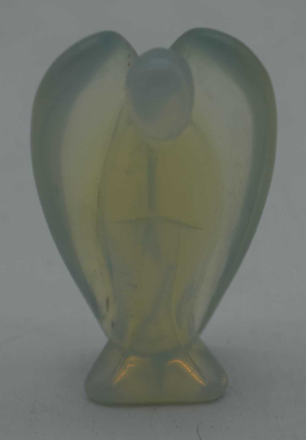 A CARVED OPAL GLASS ANGEL. 100 grams. 7.5 cm x 4.5 cm.