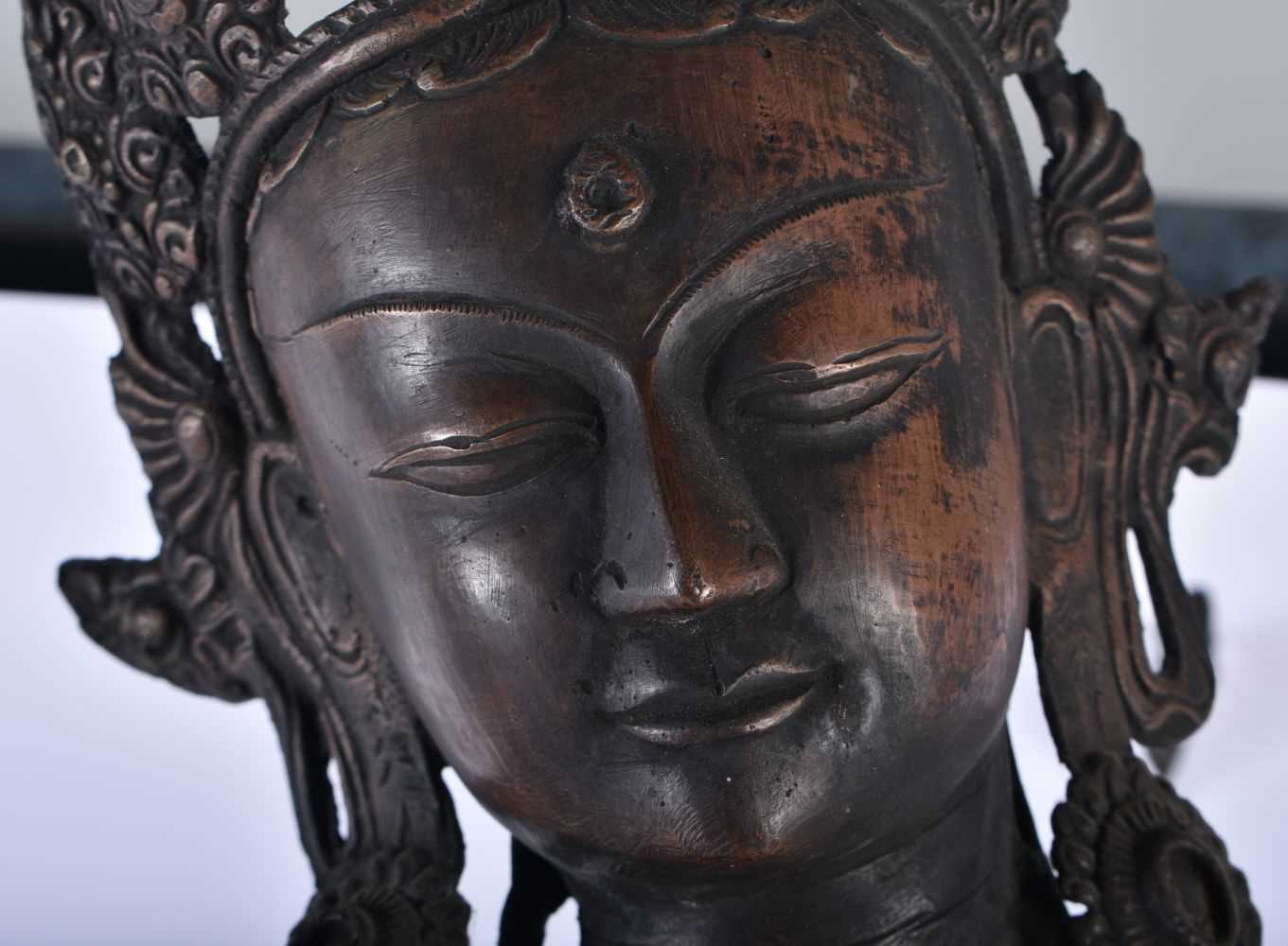 A LARGE 19TH CENTURY INDIAN TIBETAN BRONZE FIGURE OF A STANDING DEITY modelled upon a leaf form - Image 2 of 8