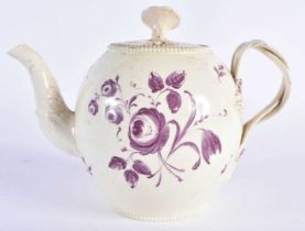 AN 18TH CENTURY ENGLISH CREAMWARE TEAPOT AND COVER painted with flowers. 18cm wide.