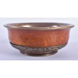 A 19TH CENTURY TIBETAN CARVED WOOD AND COPPER REPOUSSE BOWL decorated with foliage. 12 cm wide.