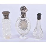 THREE ANTIQUE SILVER TOPPED GLASS BOTTLES. 103 grams overall. Largest 10 cm x 4.25cm. (3)