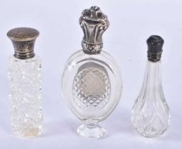 THREE ANTIQUE SILVER TOPPED GLASS BOTTLES. 103 grams overall. Largest 10 cm x 4.25cm. (3)