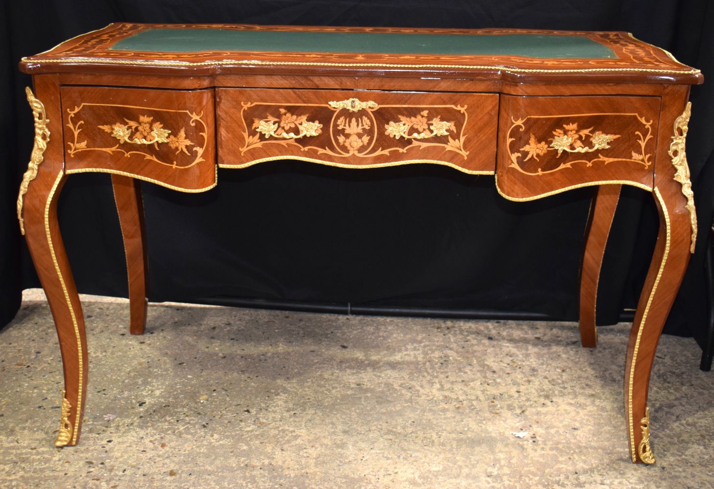 A baroque style inlaid leather topped three drawer writing desk 79 x 122 x 62 cm