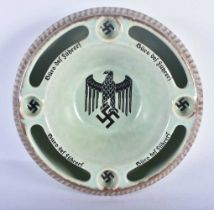 AN UNUSUAL GERMAN POTTERY ASHTRAY of WWII military interest. 15 cm diameter.