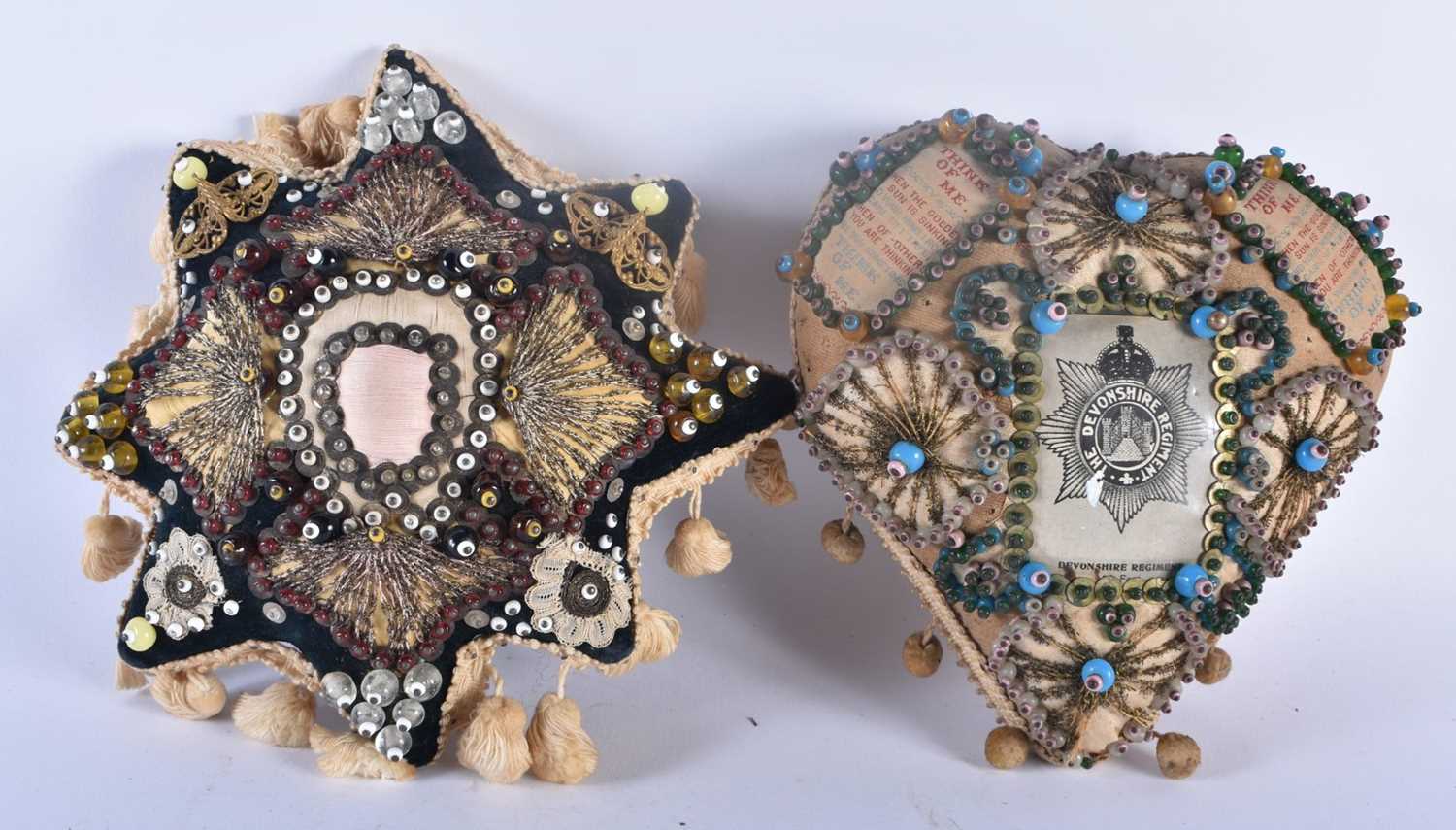 A PAIR OF ANTIQUE EMBROIDERED SILK AND BEAD WORK SWEETHEART PIN CUSHIONS one for the Devonshire