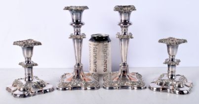 A pair of Silver plated candlesticks together with a smaller pair largest 20 cm (4).