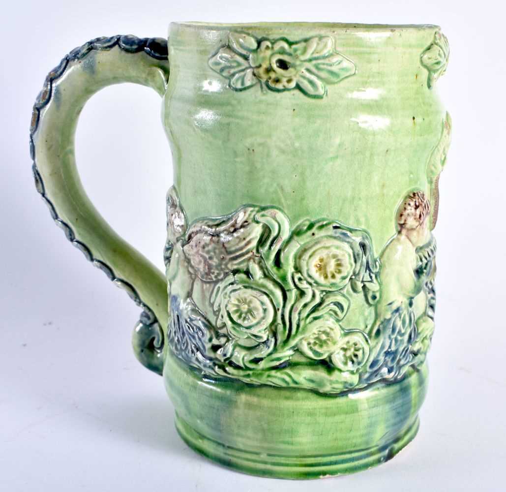 A RARE ANTIQUE GREEN GLAZED WHIELDON TYPE MAJOLICA MUG decorated in relief with figures. 14 cm x - Image 3 of 6