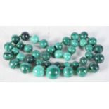 A Malachite Bead Necklace. Length 69cm, largest bead 19mm, weight 221g