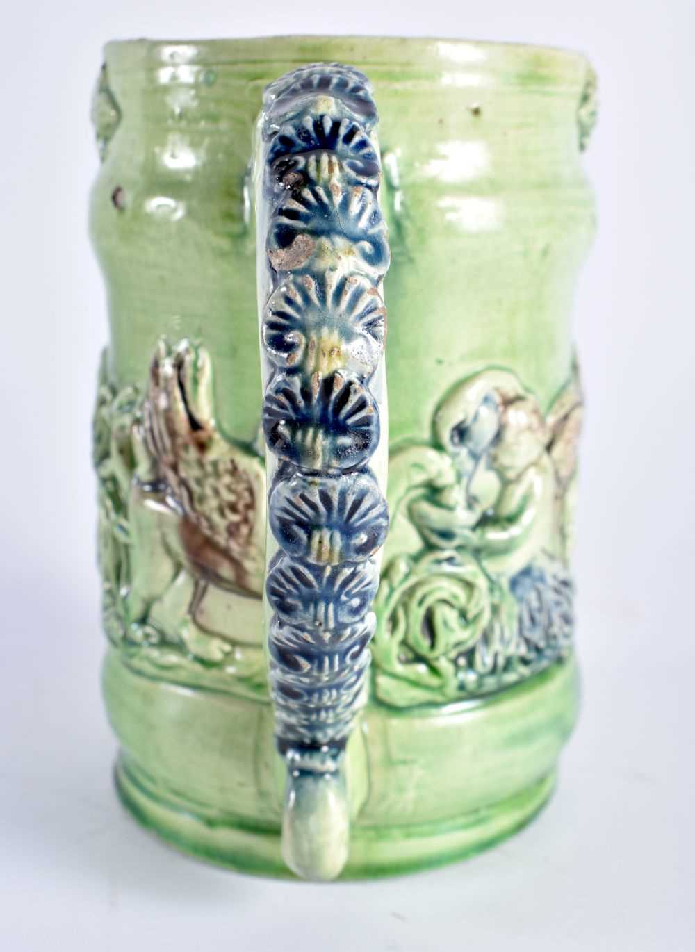 A RARE ANTIQUE GREEN GLAZED WHIELDON TYPE MAJOLICA MUG decorated in relief with figures. 14 cm x - Image 4 of 6