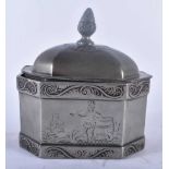 AN UNUSUAL ANTIQUE PEWTER TOBACCO BOX AND COVER engraved with a scene of a tribal male smoking a