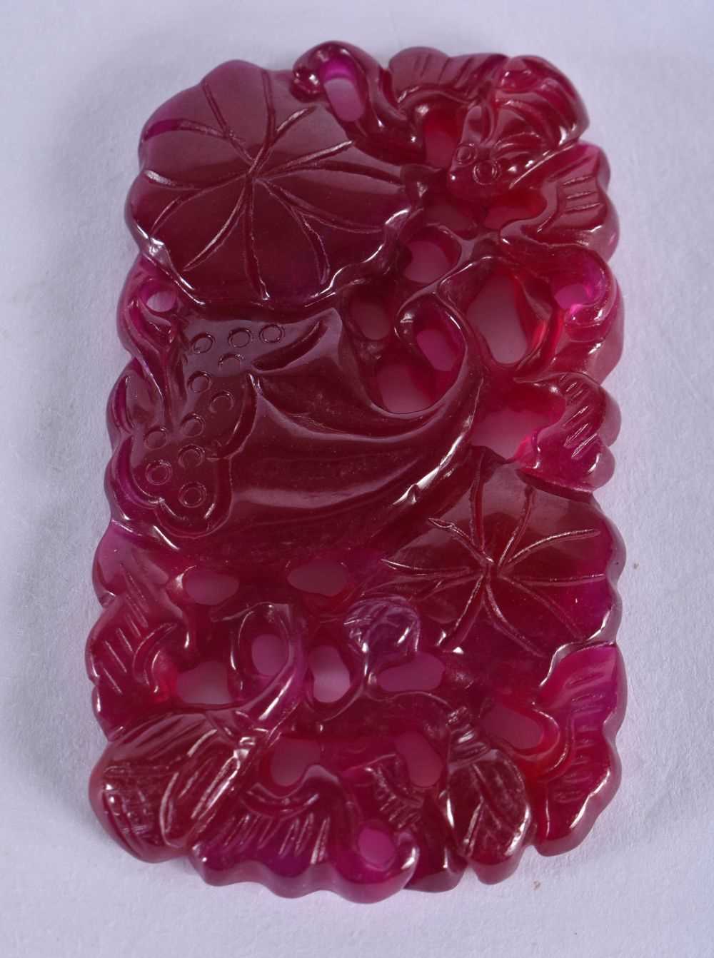 A CHINESE CARVED TOURMALINE PLAQUE 20th Century. 34.9 grams. 4.25cm x 7.25cm.