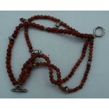 AN IMITATION CORAL WOOD NECKLACE. 35 grams. 22 cm long.