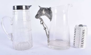 A SILVER PLATED GLASS PITCHER together with a horse head jug. Largest 22 cm x 17 cm. (2)