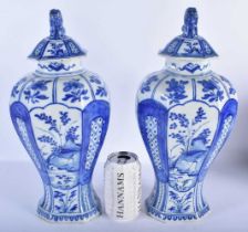 A LARGE PAIR OF 18TH CENTURY DUTCH DELFT BLUE AND WHITE VASES painted with birds in landscapes. 38