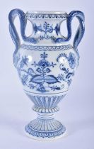 A GERMAN MEISSEN BLUE AND WHITE PORCELAIN VASE with serpent handles, painted with floral sprays.