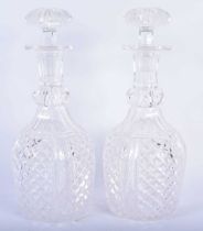 A PAIR OF REGENCY CUT GLASS DECANTERS AND STOPPERS. 28 cm high.