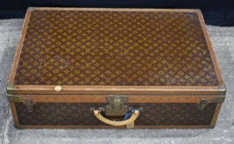 A Louis Vuitton suitcase 23 x 81 x 53 cm.