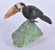 A Carved Hardstone Model of a Toucan with Silver Feet Perched on a Rock. 13 cm x 13 cm x 4.5 cm