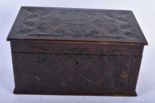 A LARGE ART NOUVEAU CARVED WOOD STATIONARY BOX decorated all over with flowers and trailing vines.