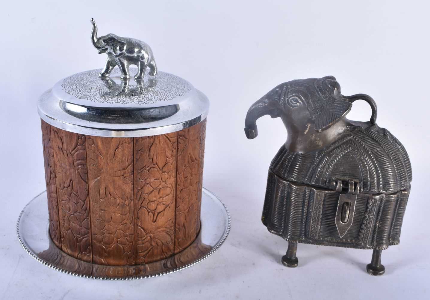 AN ANGLO INDIAN SILVER PLATED CARVED WOOD ELEPHANT BISCUIT BARREL AND COVER together with a bronze