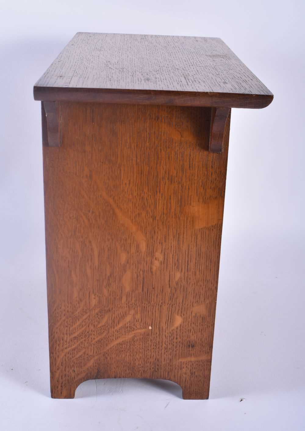 AN ART NOUVEAU OAK SMOKERS CABINET with stylised brass strapwork. 30cm x 28 cm. - Image 3 of 5